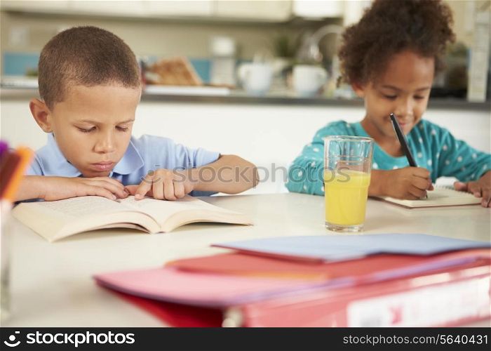 Children Doing Homework Together At Table