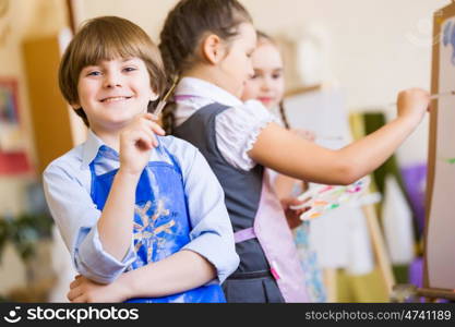 Children drawing and painting. Little children painting and playing at kindergarten