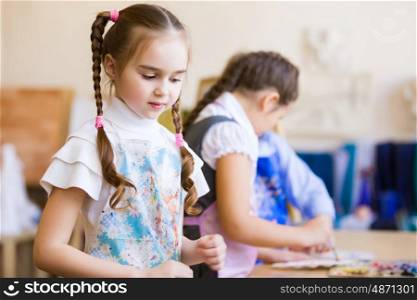 Children drawing and painting. Little children painting and playing at kindergarten
