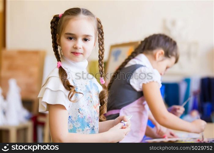 Children drawing and painting. Little children painting and playing at kindergarten