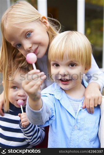 Children eating lollipops