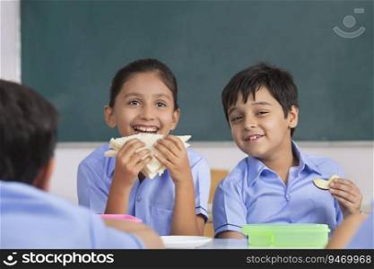 children eating sandwich in lunch in class