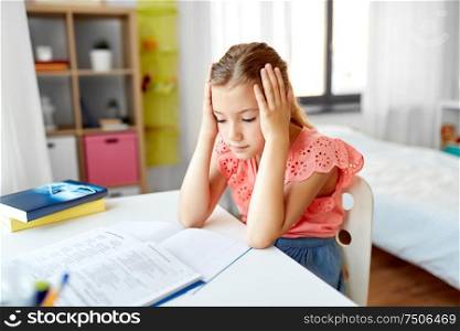 children, education and learning concept - sad student girl with notebook at home. sad student girl with notebook at home