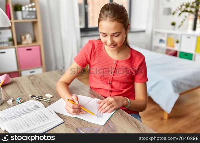 children, education and learning concept - student teenage girl with ruler drawing line in notebook at home. student girl with ruler drawing line in notebook