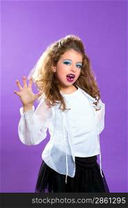 Children fashion makeup kid girl trying to scare gesture on purple