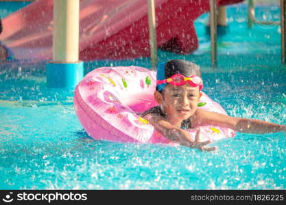 Children frolic at the water park. It is a sunny, perfect day for getting wet and playing hard.