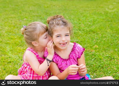 children girl sister friends whispering ear in green grass park