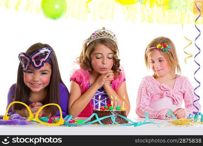 children happy girls blowing birthday party chocolate cake candles