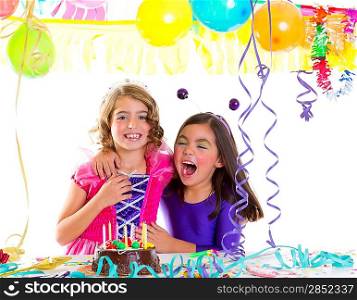 children happy hug in birthday party laughing with baloons garlands and candles cake