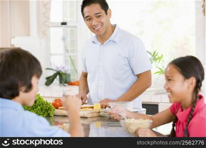 Children Having Breakfast While Dad Prepares Food