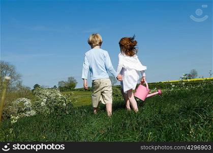 Children holding hands in field