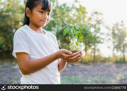 children holding small tree for planting. concept earth day