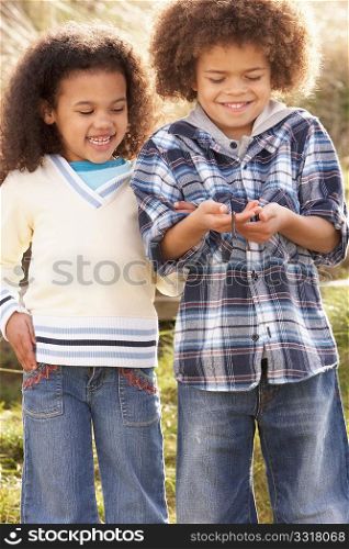 Children Holding Worm Outdoors