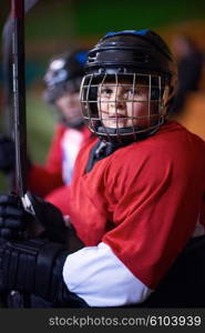 children ice hockey players, group of people, team friends waiting and relaxing on bench to start game