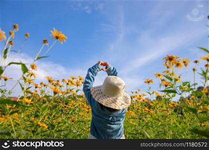 Children in the field yellow flowers yellow. Dutch girl in white hat