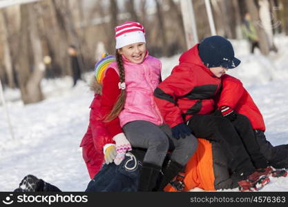 Children in winter park having fun and playing snowballs. Winter activities