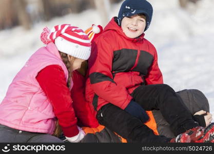 Children in winter park having fun and playing snowballs. Winter activities