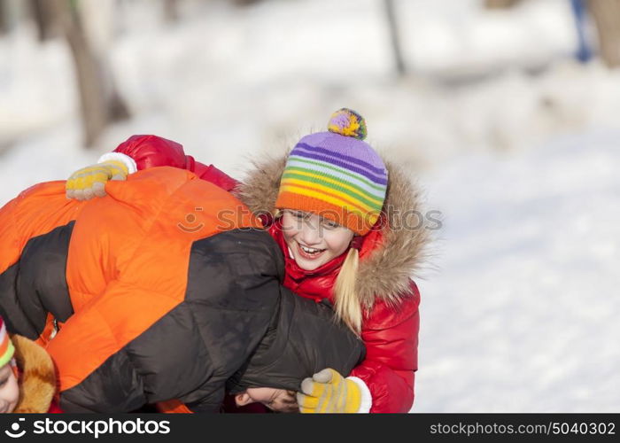 Children in winter park having fun and playing snowballs. Winter activities