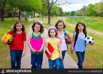 Children kid girls walking to schoool with sport balls folders and backpacks in outdoor park