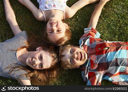 Children laying in grass together