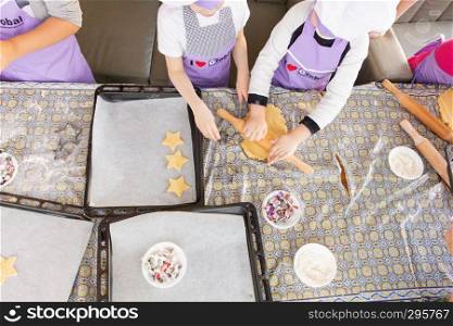 Children learn to cook cookies in the form of an asterisk. Fitness club global.. Khabarovsk, Russia - Feb17, 2018: cooking class for the production of cookies for his father in honor of the defender of the Fatherland.