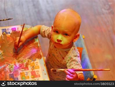 Children little boy draws with colored inks