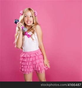 children little star singer like blond fashion doll with mic over pink background