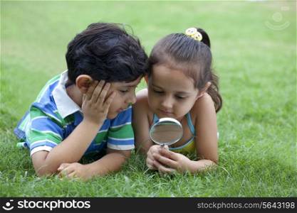 Children looking through magnifying glass