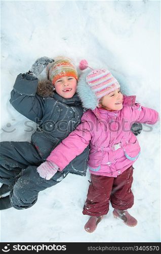 Children lying on snow