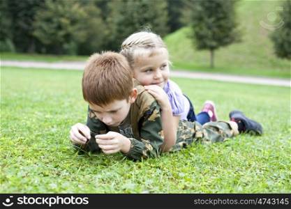 Children lying on the green grass in the park
