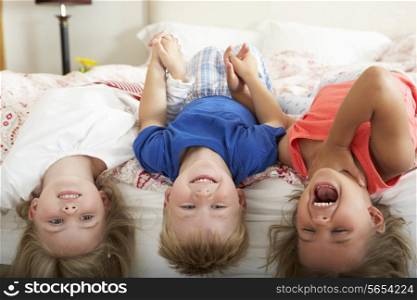 Children Lying Upside Down Bed