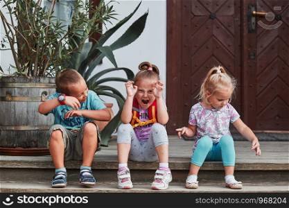 Children making silly faces. Kids having fun showing goofy poses posing to camera. Real people, authentic situations