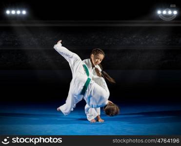 Children martial arts fighters in sports hall