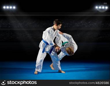 Children martial arts fighters in sports hall