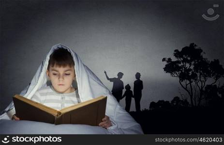 Children nightmare. Little cute boy sitting in bed under blanket with book
