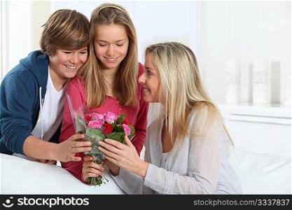 Children offering bunch of flowers on mother&acute;s day