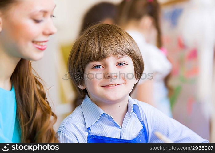 Children painting with teacher