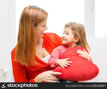 children, parenthood and happiness concept - happy mother and child with big red heart at home