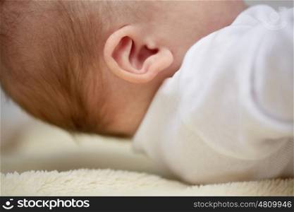 children, people and care concept - close up of baby ear