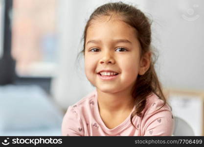 children, people and childhood concept - portrait of happy smiling little girl at home. portrait of happy smiling little girl at home