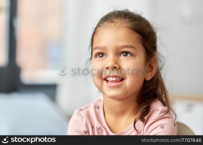 children, people and childhood concept - portrait of happy smiling little girl at home. portrait of happy smiling little girl at home