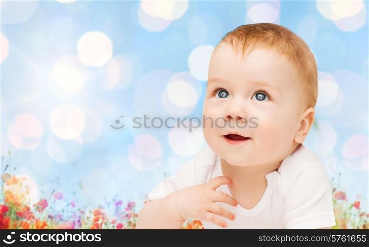 children, people, infancy and age concept - beautiful happy baby over blue lights and poppy field background