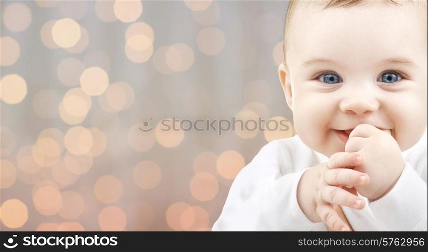 children, people, infancy and age concept - beautiful happy baby over holidays lights background