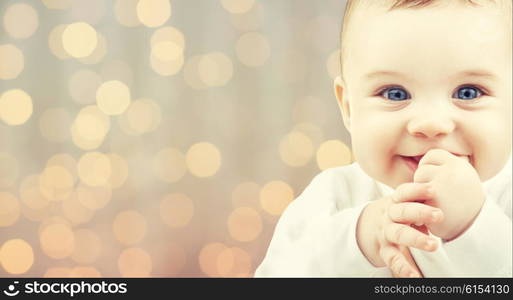 children, people, infancy and age concept - beautiful happy baby over holidays lights background