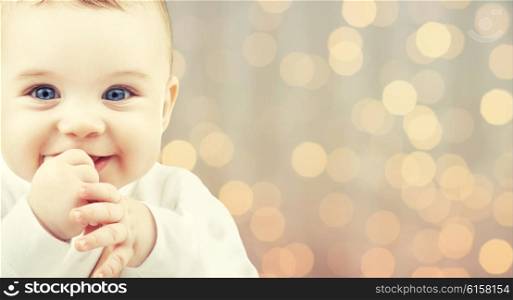 children, people, infancy and age concept - beautiful happy baby over holidays lights background