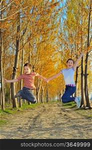 children play in forest in autumn time