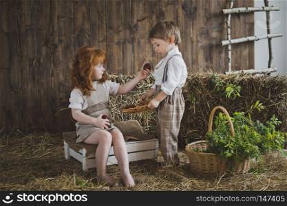 Children play with Easter eggs in the barn.. Little children see the Easter eggs 6074.