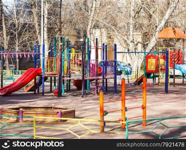 children playground in urban yard in spring