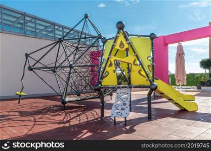 Children playground with climbing stand and slide park in the fairground
