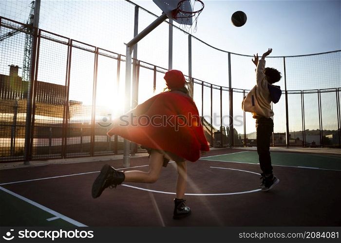 children playing basketball together outdoors